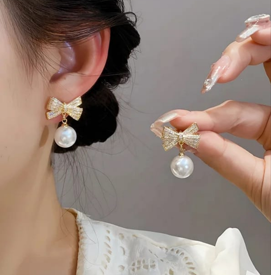 Bow earrings with pearl hangings